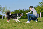 man with Australian Shepherd