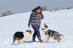 woman with 2 dogs in the snow