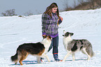 woman with 2 dogs in the snow