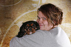 woman and Cavalier King Charles Spaniel