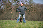 woman and Flat Coated Retriever Puppy