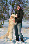 woman and Golden Retriever in snow