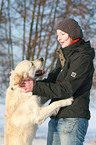 woman and Golden Retriever in snow