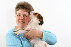 woman snuggles with Jack Russell Terrier