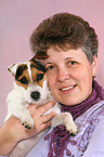 woman snuggles with Jack Russell Terrier