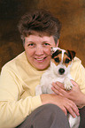 woman snuggles with Jack Russell Terrier