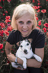 woman with Jack Russell Terrier in the poppy field