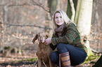 woman and shorthaired Magyar Vizsla