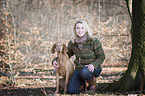 woman and shorthaired Magyar Vizsla