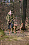 woman and 2 shorthaired Magyar Vizslas