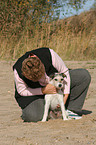 woman fondles Parson Russell Terrier