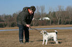 woman plays with Parson Russell Terrier