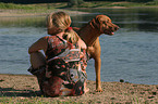 woman with Rhodesian Ridgeback on the beach