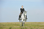 woman rides Andalusian horse