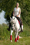 woman rides Andalusian horse