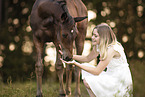 woman and Austrian warmblood foal