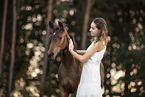 woman and Austrian warmblood foal