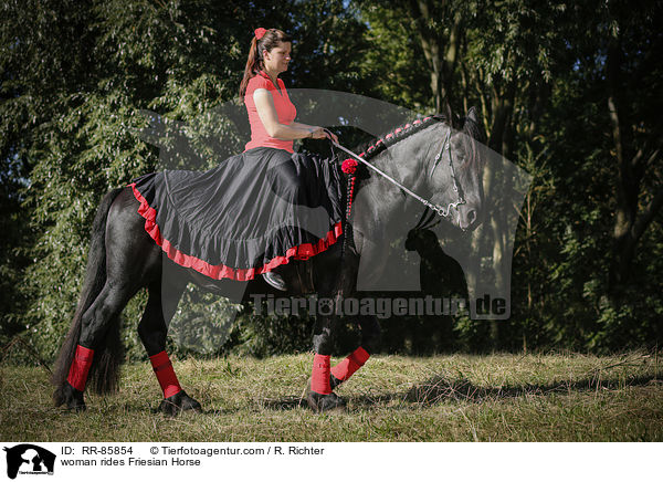 woman rides Friesian Horse / RR-85854