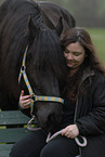 woman and Frisian horse