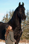 girl and Frisian horse