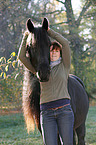 woman and Frisian horse