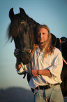 man and Frisian horse