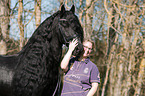 woman and Friesian horse