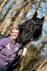 woman and Friesian horse