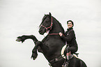 woman rides Frisian Horse