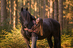 girl and Frisian horse