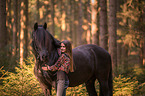 girl and Frisian horse