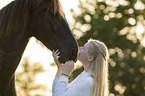 woman and Frisian horse