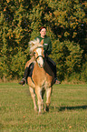 woman rides haflinger horse