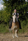 woman rides Haflinger horse