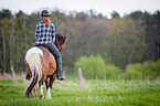 woman rides Icelandic horse