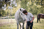 man and 2 horses