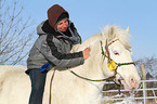 woman rides pony