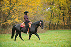 woman rides Quarter Horse