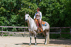 woman rides Quarter Horse