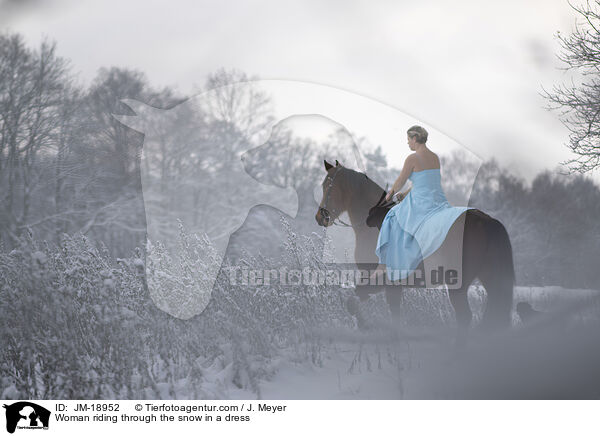 Woman riding through the snow in a dress / JM-18952