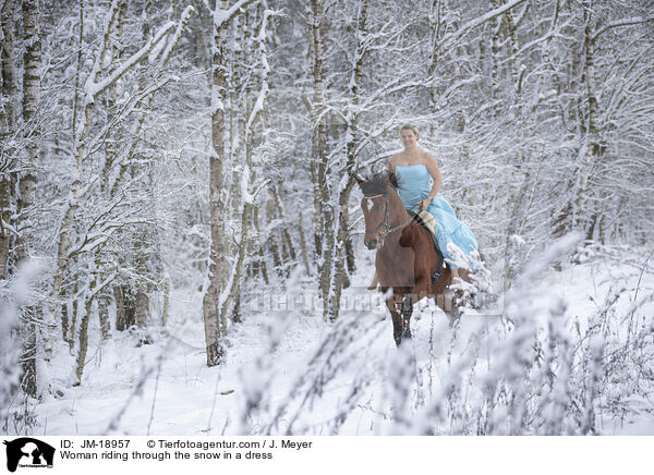 Woman riding through the snow in a dress / JM-18957