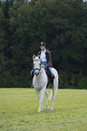 woman rides warmblood