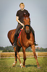 woman rides warmblood